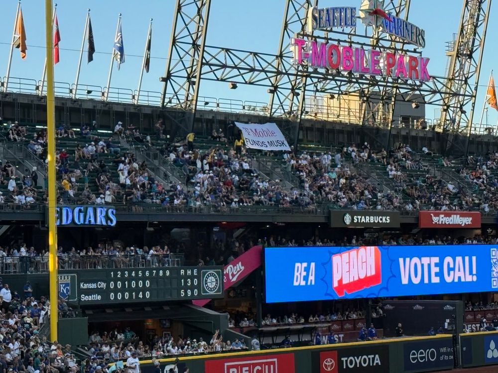 Giant banner under T-Mobile sign in the bleachers that reads "T-Mobile funds Musk" from a further distance