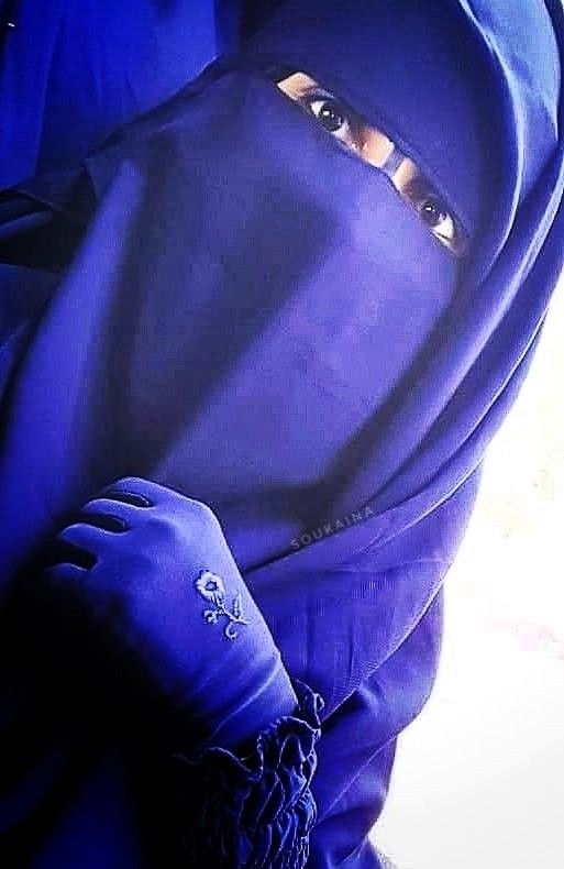 Woman wearing a Blue Niqab Gloves and Abaya that cover her whole body 