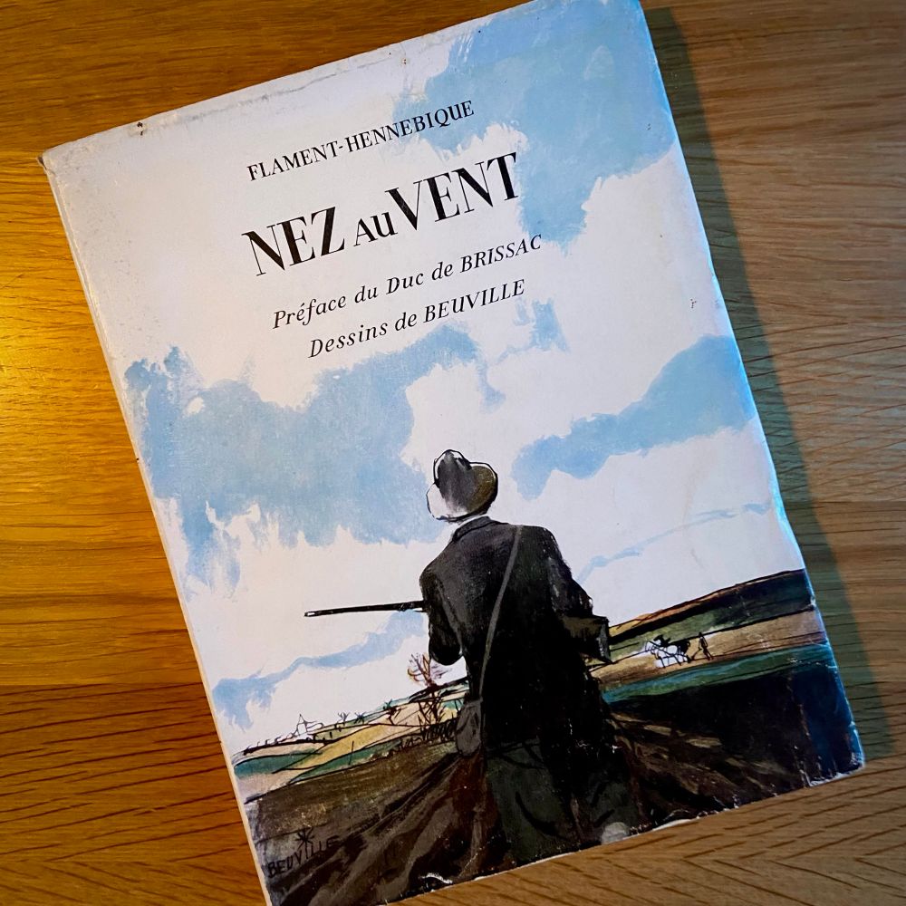 Photo of the French book ‘Nez au Vent’ with a full color illustration of a hunter against the sky by Georges Beuville