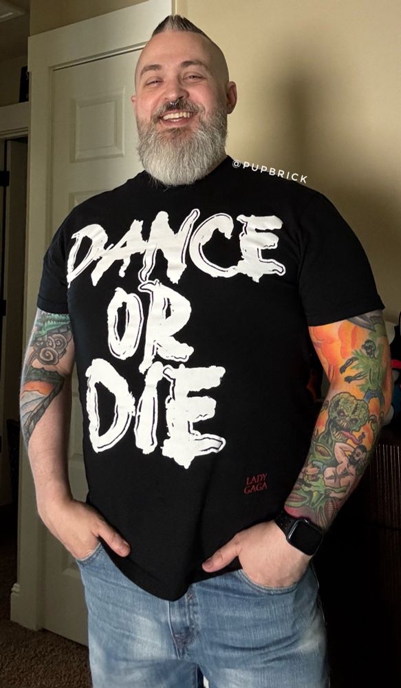 dad wearing a t-shirt that says "dance or die," which is a reference from the Abracadabra music video by Lady Gaga