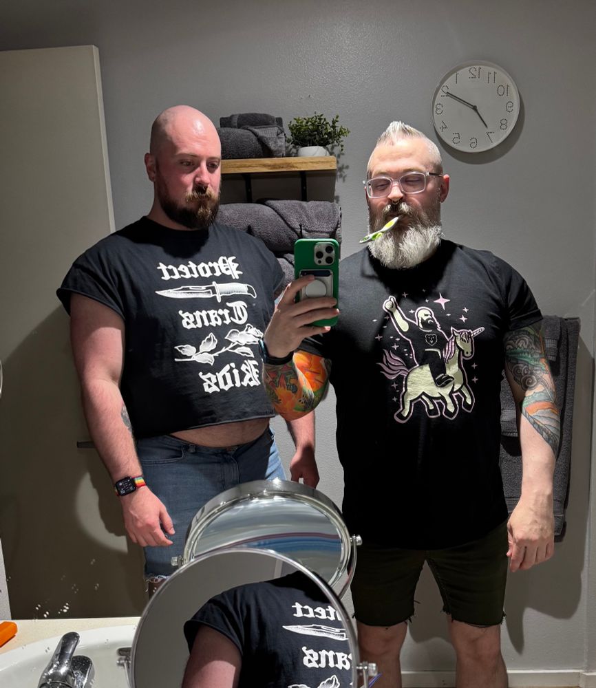 two gays in the harshest bathroom lighting ever found