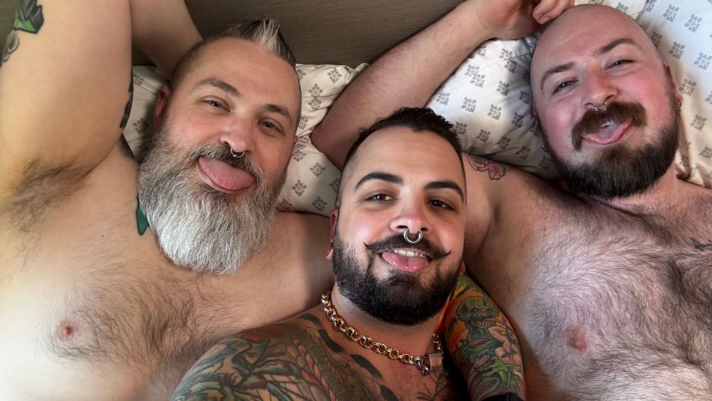 three gays snuggling in bed