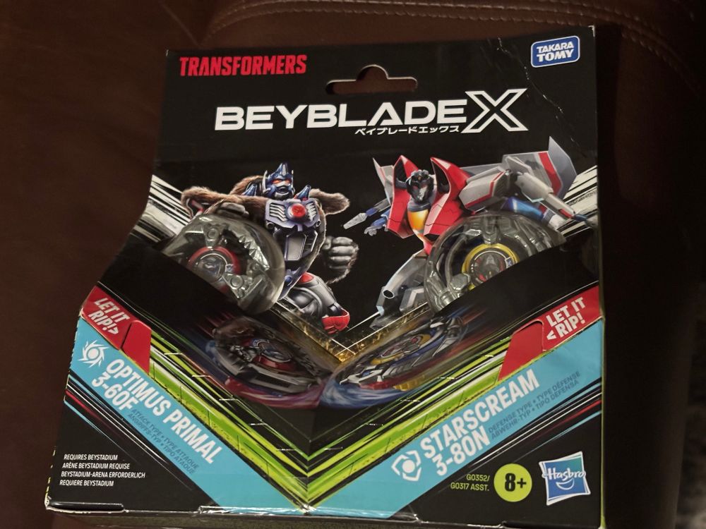 Collaberative Beyblade X set featuring Optimus Primal (3-60F) and Starscream (3-80N) from Transformers, presumably paired due to the iconic episode in Beast Wars Transformers where a "G1" Starscream takes possesion of Waspinator.