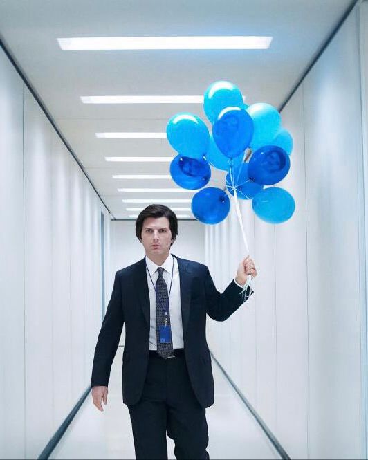 Mark looks pretty perturbed to be carrying 11 blue balloons.