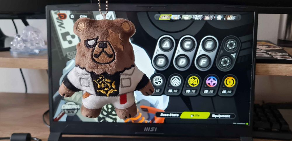A plush of Ben Bigger held in front of his in-game model.
