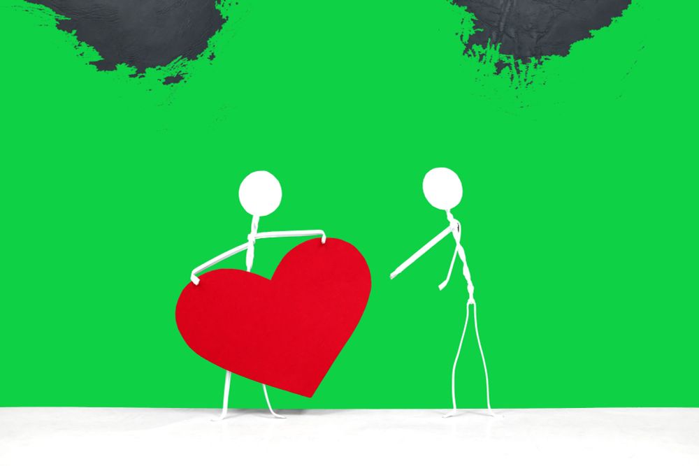 A stick person is sharing a heart.