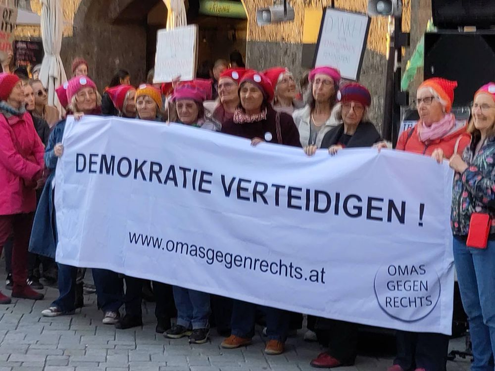 Mehrere Omas gegen Rechts mit einem Transparent mit der Aufschrift „Demokratie verteidigen.