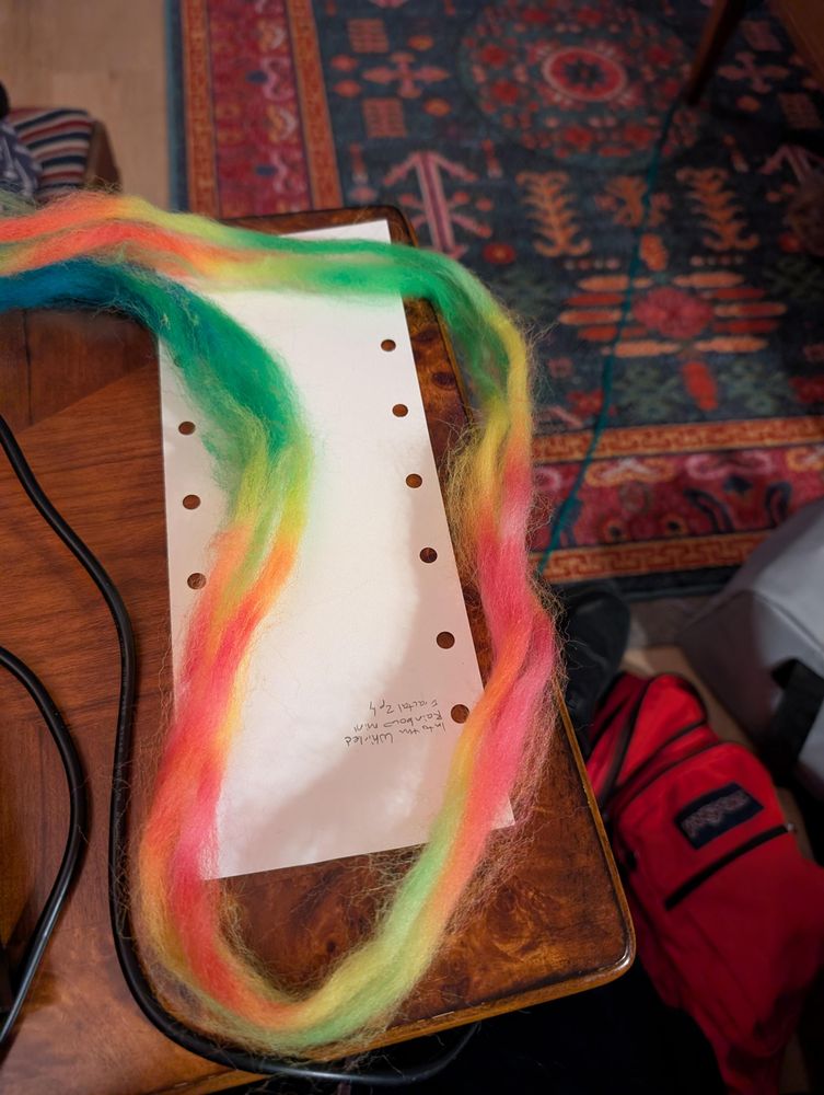 Thin strips of combed top in neon stripes going from blue through green and yellow to orange