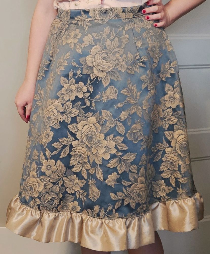 Photo of a person wearing a deep blue and gold rose skirt