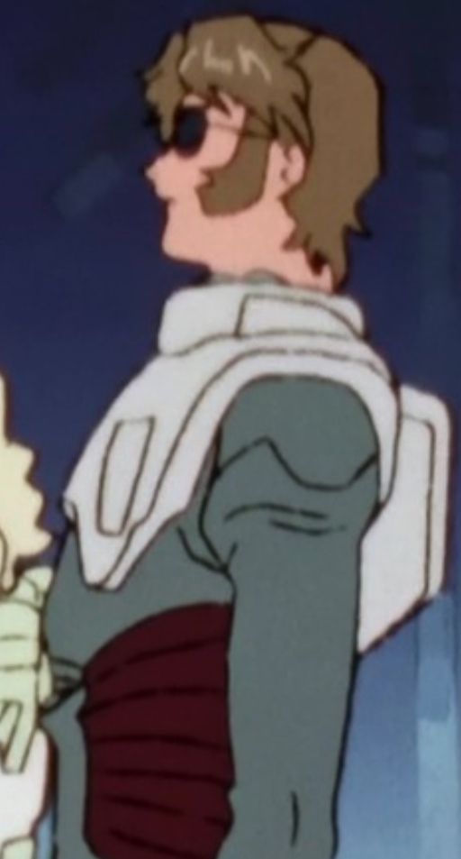 zoomed in cropped screenshot of jamil in a normal suit without a helmet. his face is rendered in low detail so his mouth and ears are more of a suggestion