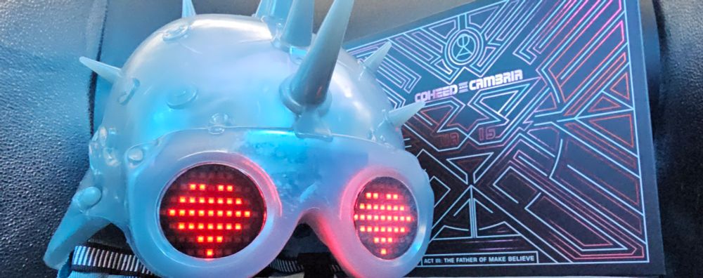 Blind Side Sonny's helmet alongside the hardcover novella for Coheed and Cambria's Vaxis act 3: the Father of Make Believe collector's edition box set