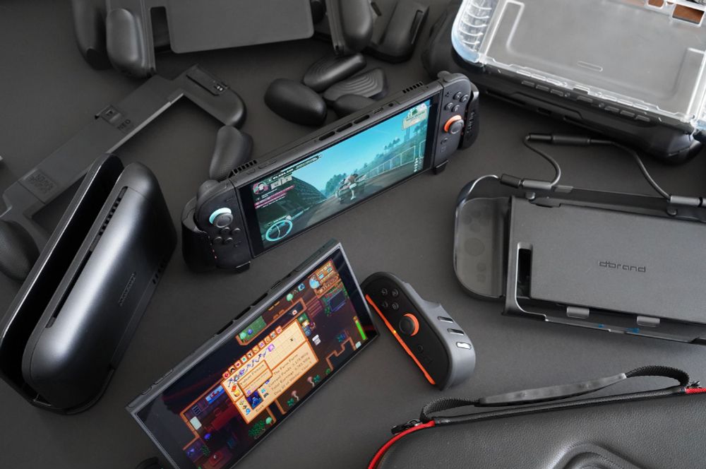 Various Nintendo Switch 2 grips and cases on a soft black tabletop