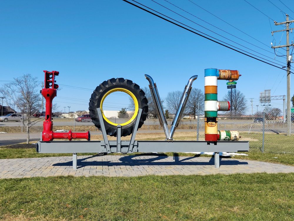 Photo of the word LOVE made out of car and truck parts. Probably about 10 feet tall. It is at the Keystone Grill in Colonial Heights Virginia. They have a museum with trucks & tractors along with other cool stuff. 