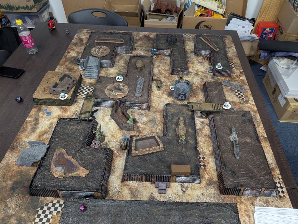 Trench crusade map with terrain and miniatures.
