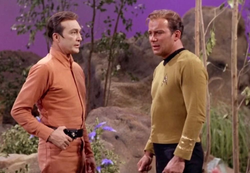 screencap from the STAR TREK episode "By Any Other Name". Commander Rojan (Warren Stevens) has the drop on Captain Kirk (William Shatner).