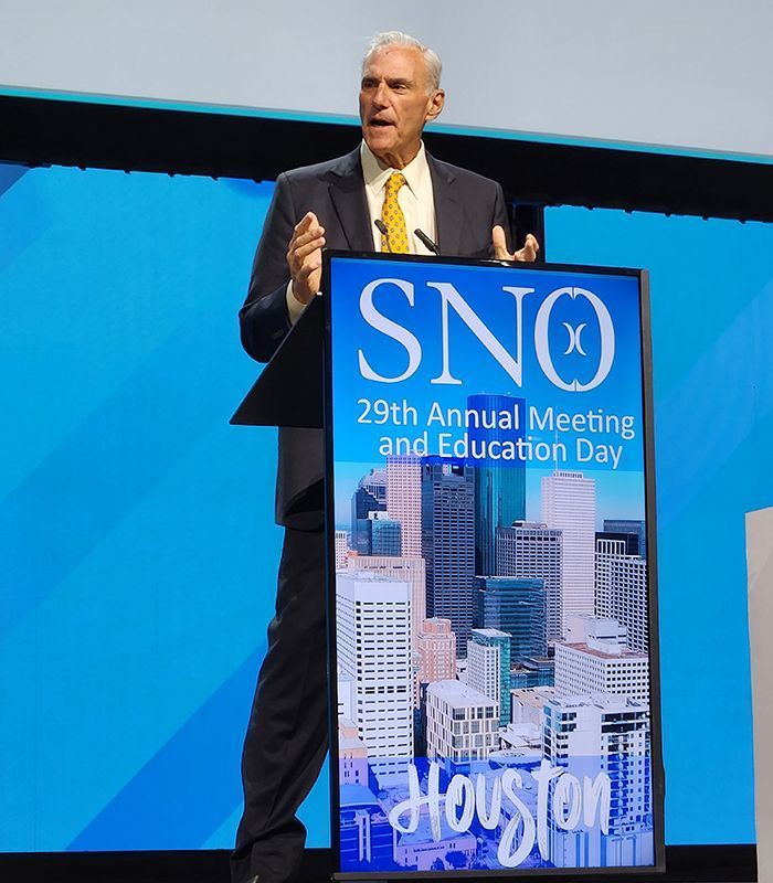 UCSF Brain Tumor Center director Mitchel Berger, MD, stands behind the podium delivering his acceptance speech during the Society for Neuro-Oncology's 29th Annual Meeting and Education Day in Houston.