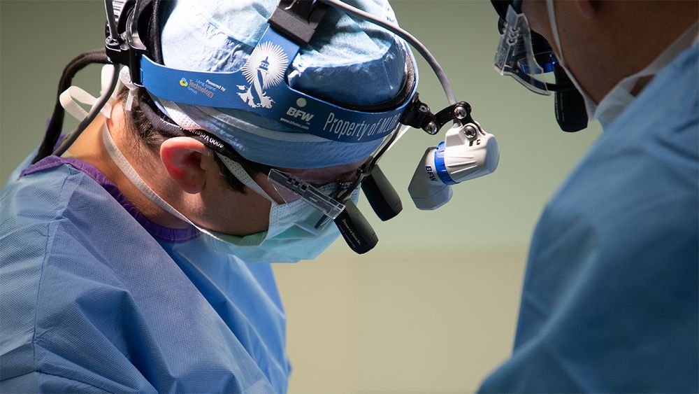 John Andrews, MD, shown looking down during a corpus callosotomy surgery.