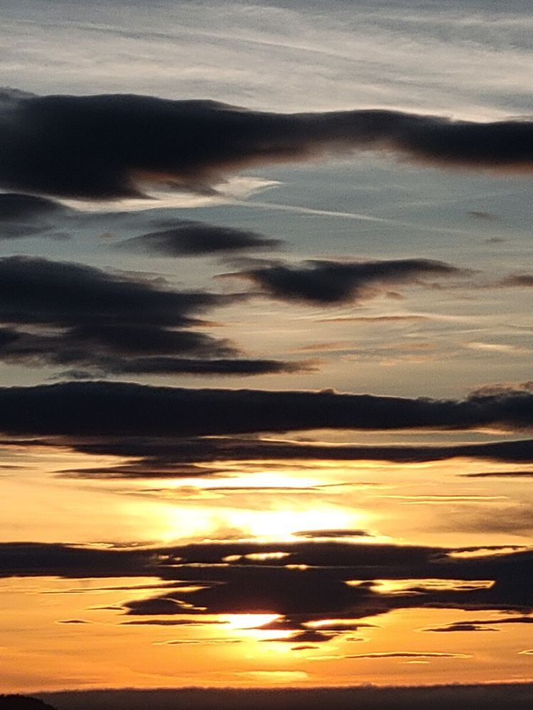 Sun starting to set and coloring the horizon with a warm orange
