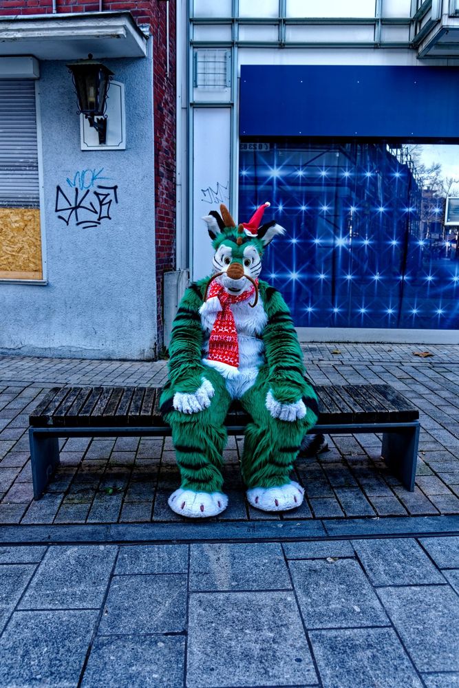 Phasor in Fursuit sitting on a bench alone. 