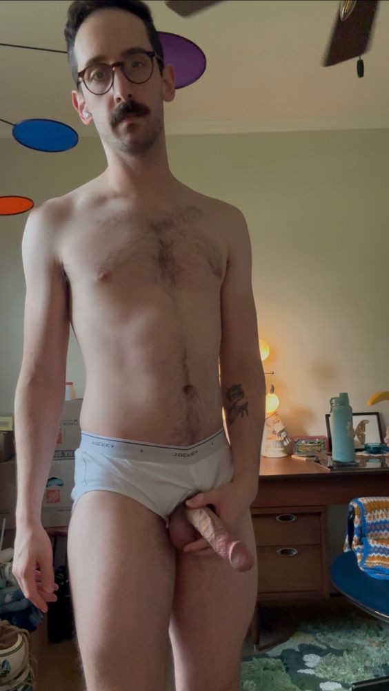 Holding my semi-hard cock through the fly of my jockies 