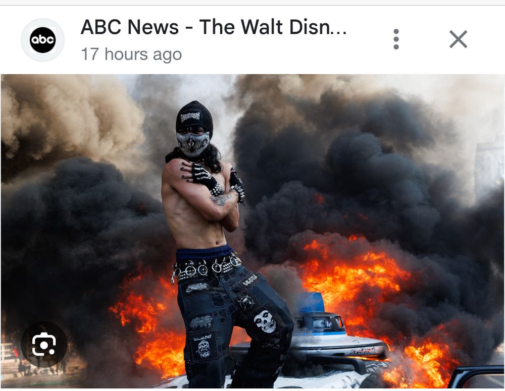 Possibly heavily photoshopped photo of agitator in LA. The face and hands looks very photoshopped.
