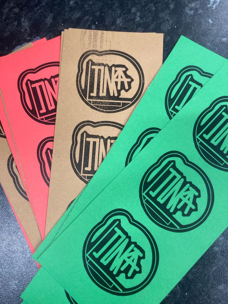 Small Junkatat logo on red, gold and green card. 