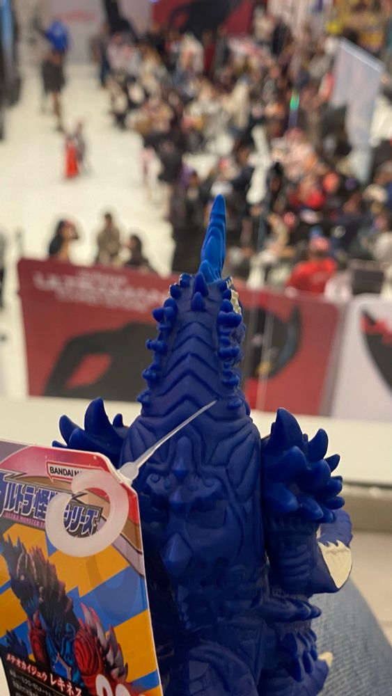 Rekiness sofubi looking down at the crowd from the second floor from atop my knee. Tag still attached because how do you get that out of the vinyl