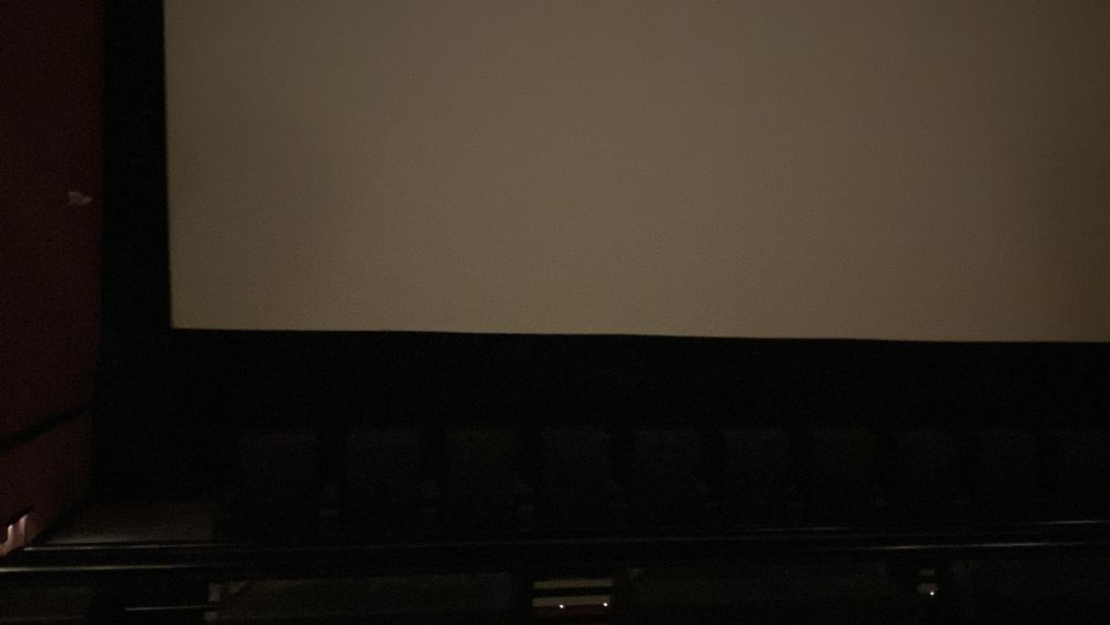 A theater far enough before the screening that the lights are up and screen empty