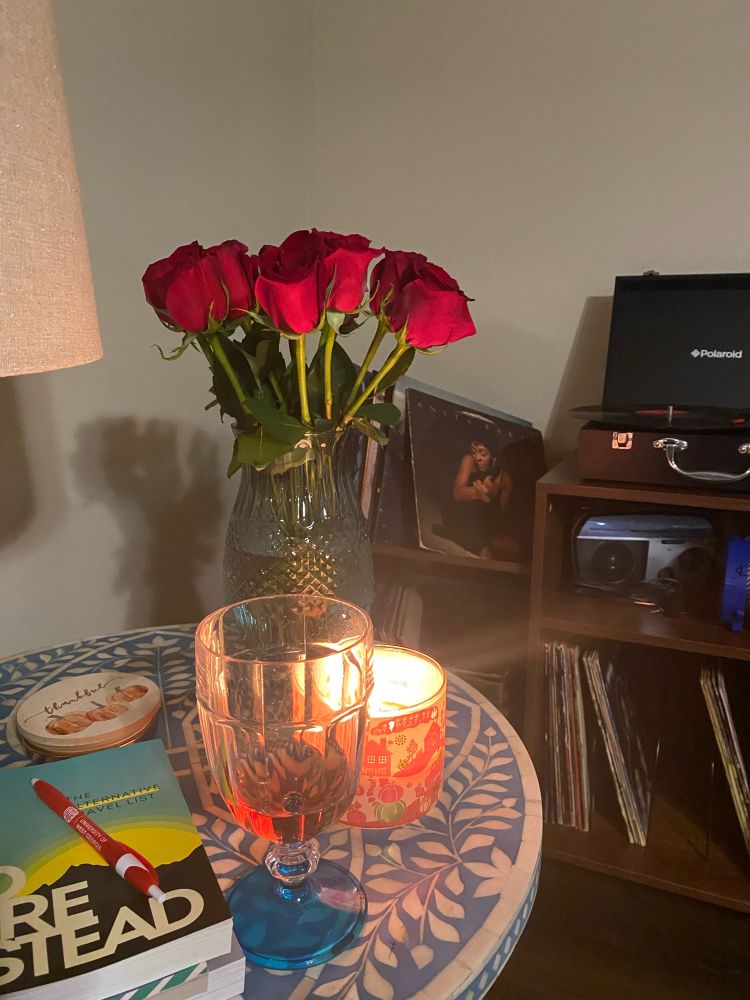 Record player spinning Anita Baker, roses, candle, & wine.