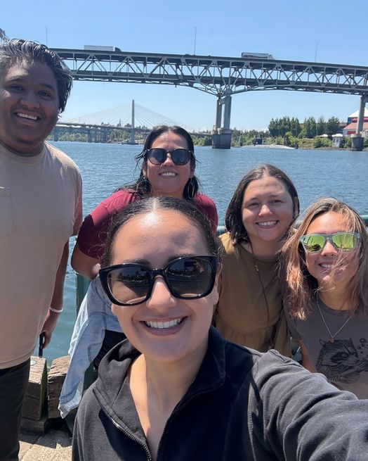 Marisol and 4 staff members in front of the Williamette River.