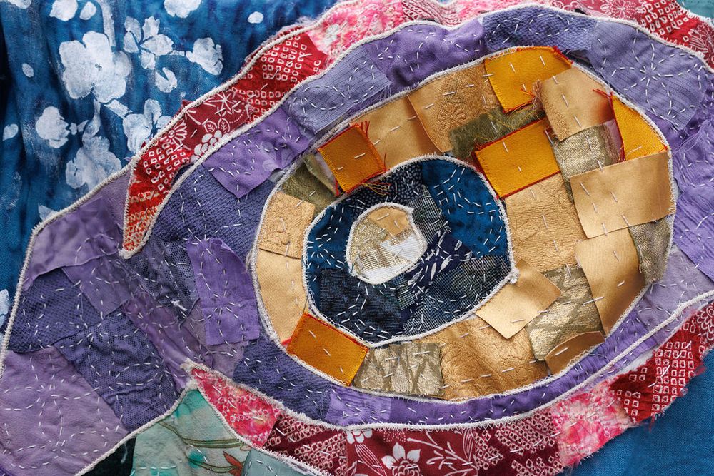 a mix of boro, sashiko, and dyed kimono squares make up an applique on a sleeve for medicine seller cosplay from mononoke