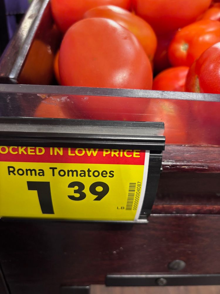 A grocery store label showing roma tomatoes at a dollar 39 cents a pound.