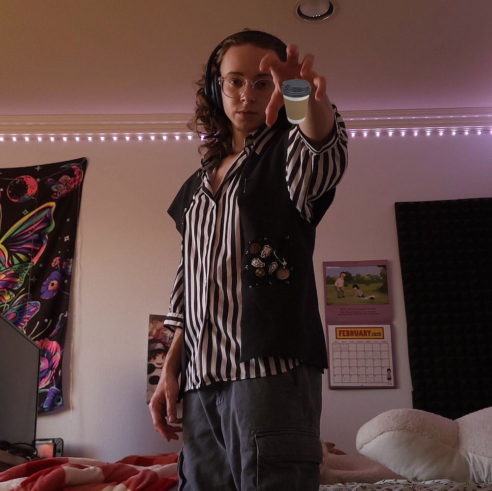 Orion; white, transmasc, long curly hair. They're standing in a bedroom with moody pink lighting. They have one arm raised and their hand in a claw formation. A to-go coffee cup is edited into their hand. The camera is placed low and angled upwards 