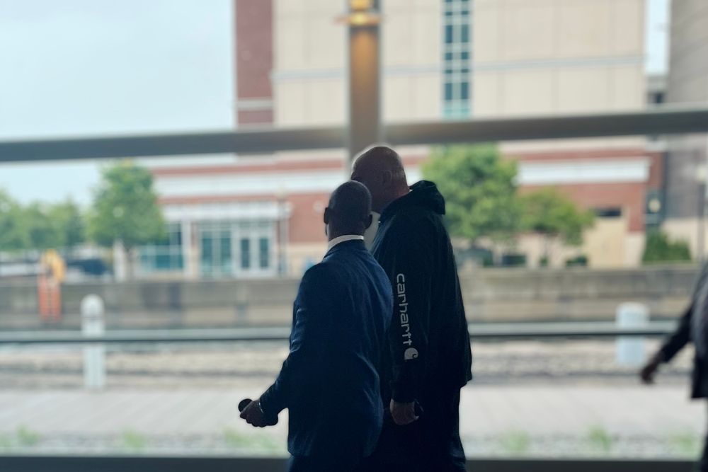 Senator Fetterman walking with HUD Secretary Scott Turner.