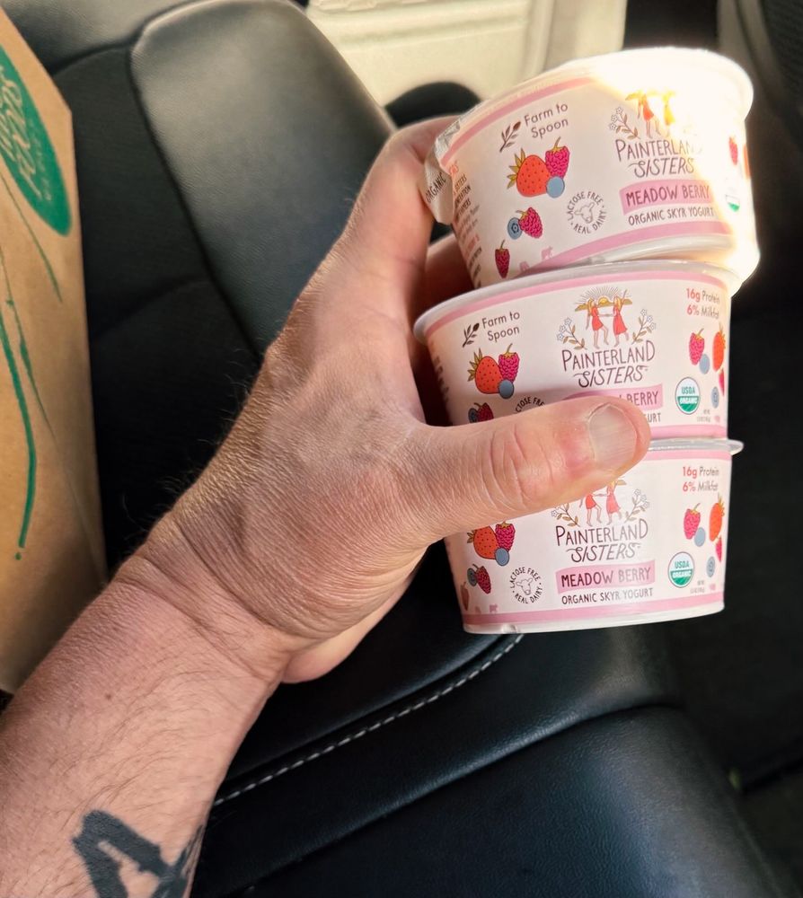 A picture of Senator Fetterman holding three small containers of Painterland Sisters yogurt — a product of Tioga County, Pennsylvania.