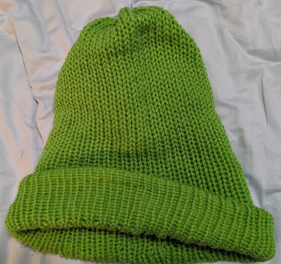 Knit hat in lime green yarn, knit on a circular knitting machine
