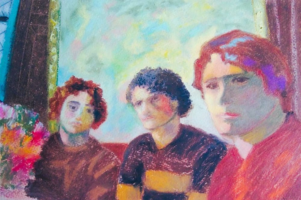 Three annoyed-looking young men sat in a pub