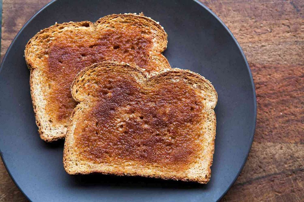 Two slices of plain toast, just bread, toasted, nothing else. On a plate but thats not important