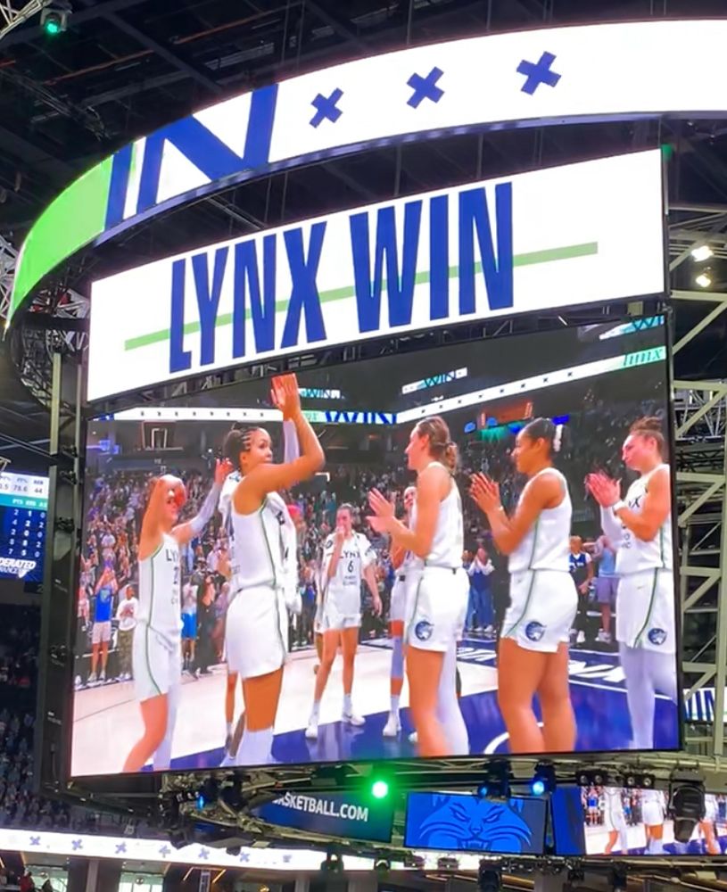 Target Center arena big screen showing Napheesa Collier and the Minnesota Lynx celebrating their win over the Phoenix Mercury.