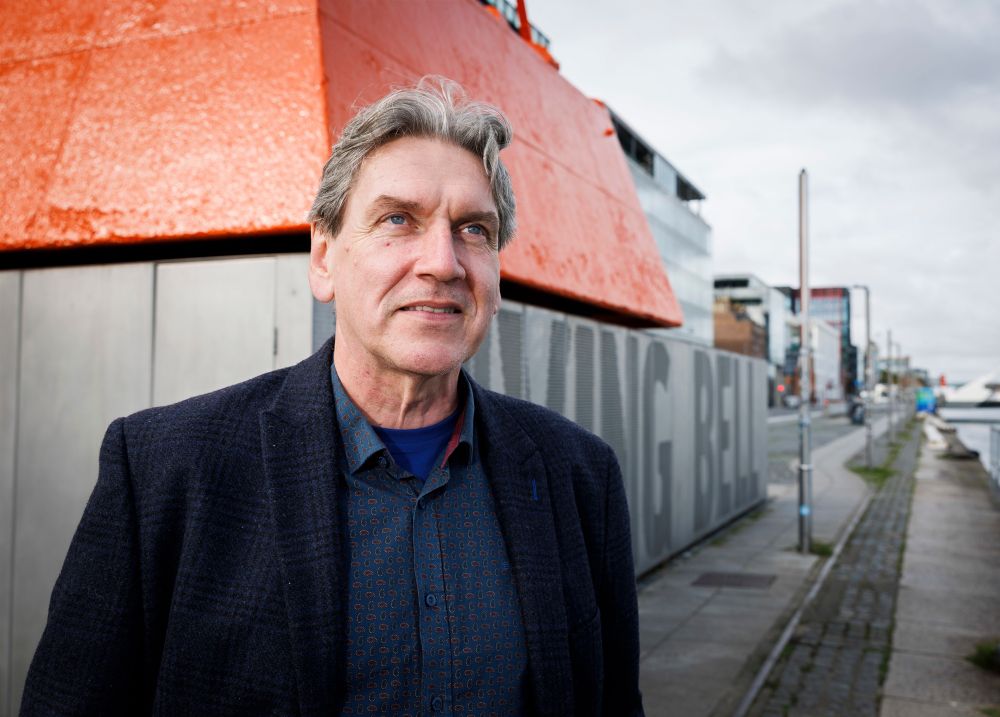 A photo of Seán Rocks smiling in Dublin Docklands. 