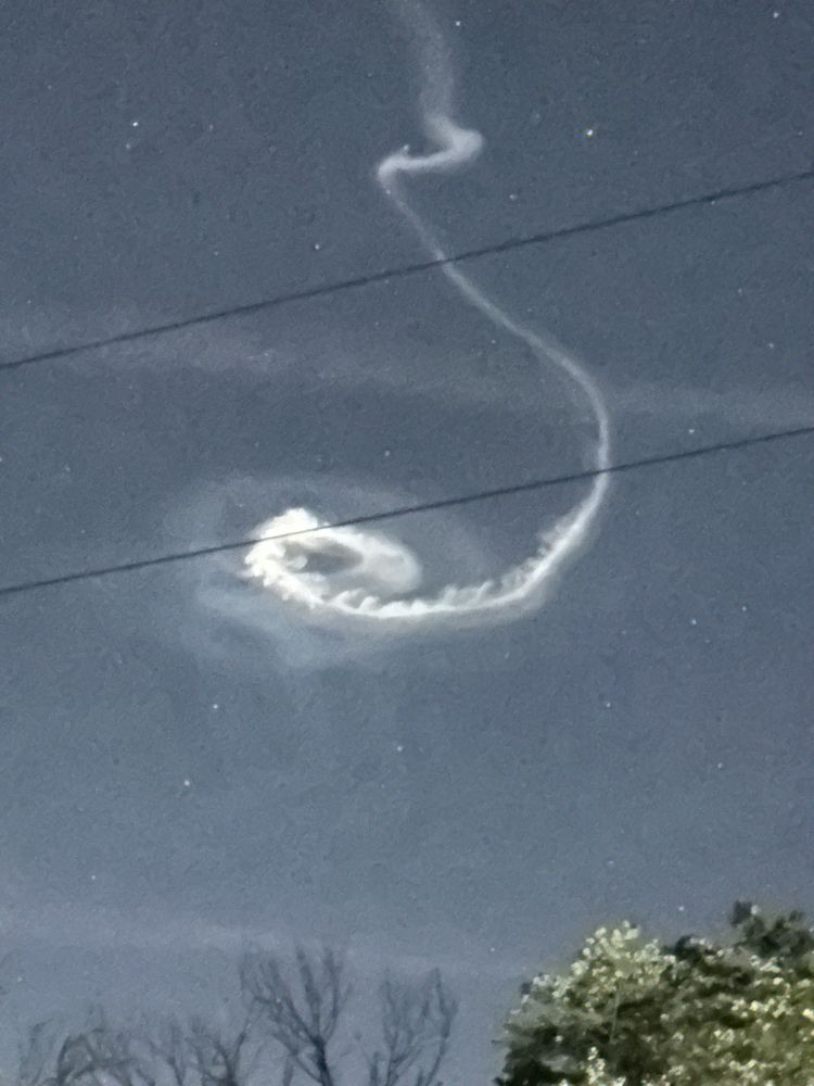 Nighttime sky lit by bright vapor trails in an odd pattern. From rocket launch at Wallops Island in Virginia USA.