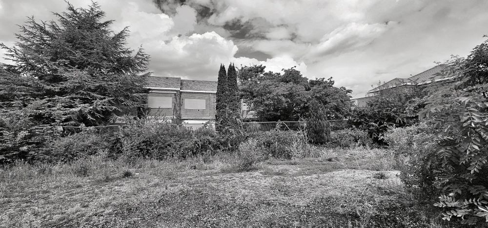 A black and white photo of an abandoned hotel. 