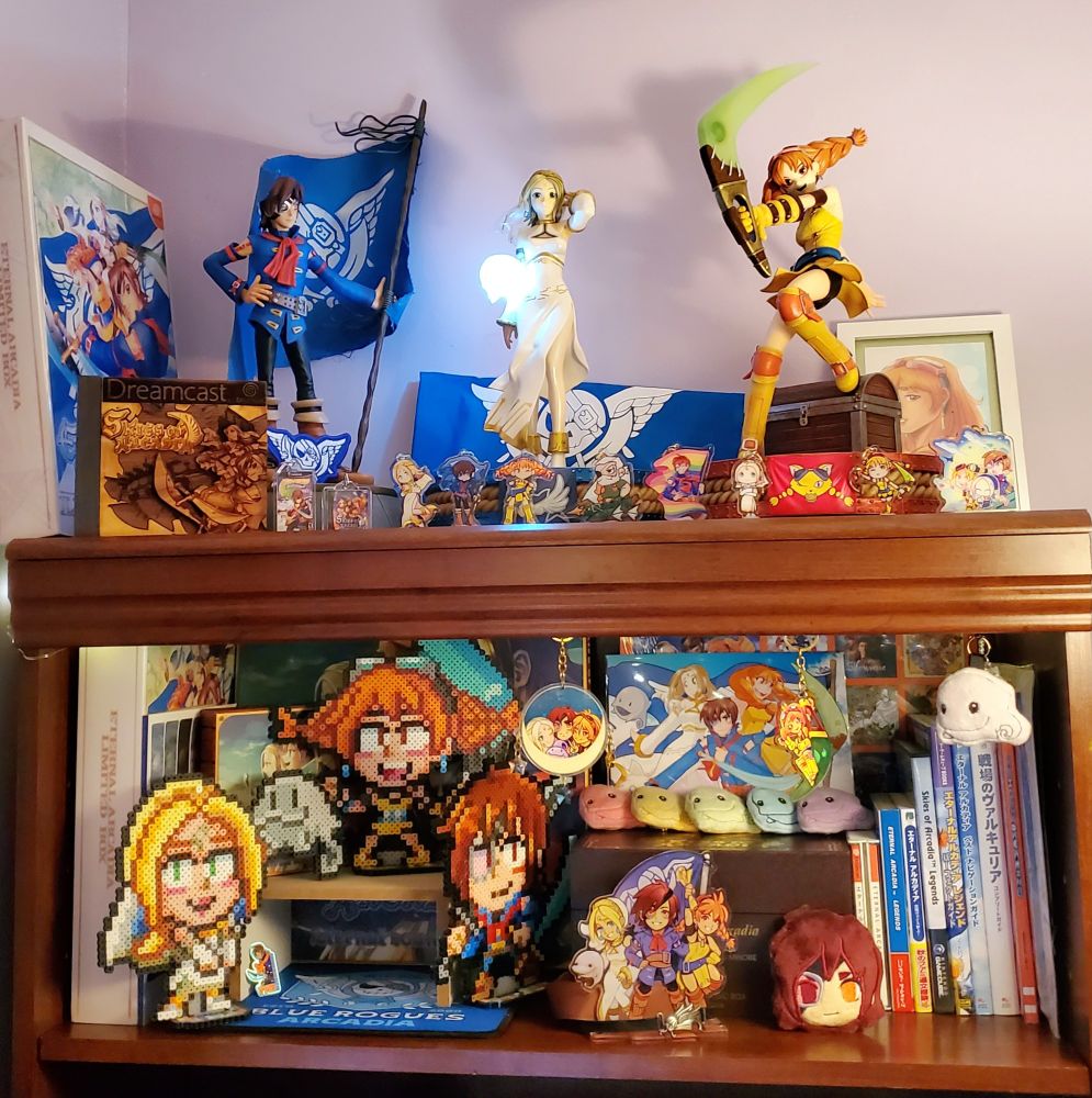 Mana's Skies of Arcadia collection! It has the F4F trio, books, perler bead standees, the music box, six Cupil keychains, a lot of other Skies keychains, and other things. I really need to make a breakdown post with everything because a lot of things aren't even visible. If you're reading this and want me to make a list of everything I will! 