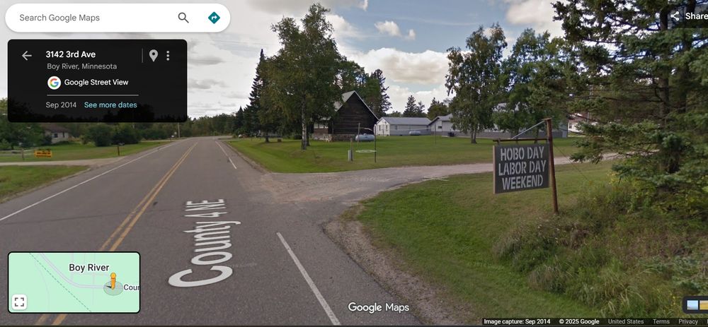 A google streetview screen shot of a small town called 'Boy River' in Minnesota - the road listed is county road 4 NE. The camera shows a sign on a rural property stating 'HOBO DAY LABOR DAY WEEKEND' This camera view is from Sept of 2014