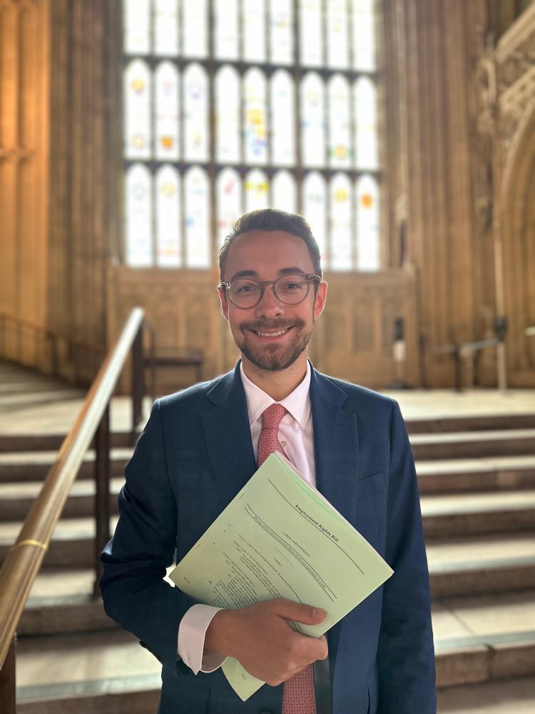Luke in Westminster Hall holding the Employment Rights Bill