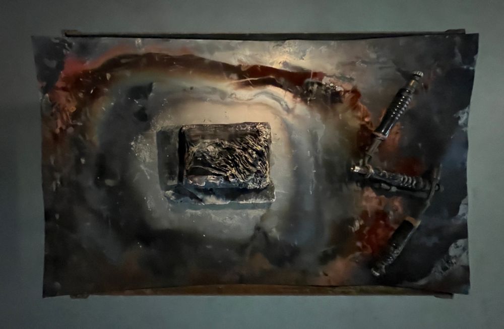 Charred book on metal plate with welding torches