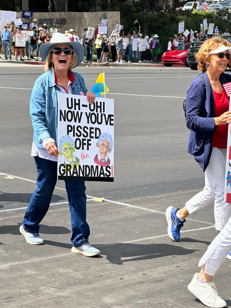 A wise woman with sign that reads “uh-oh now you’ve pissed off the grandmas”