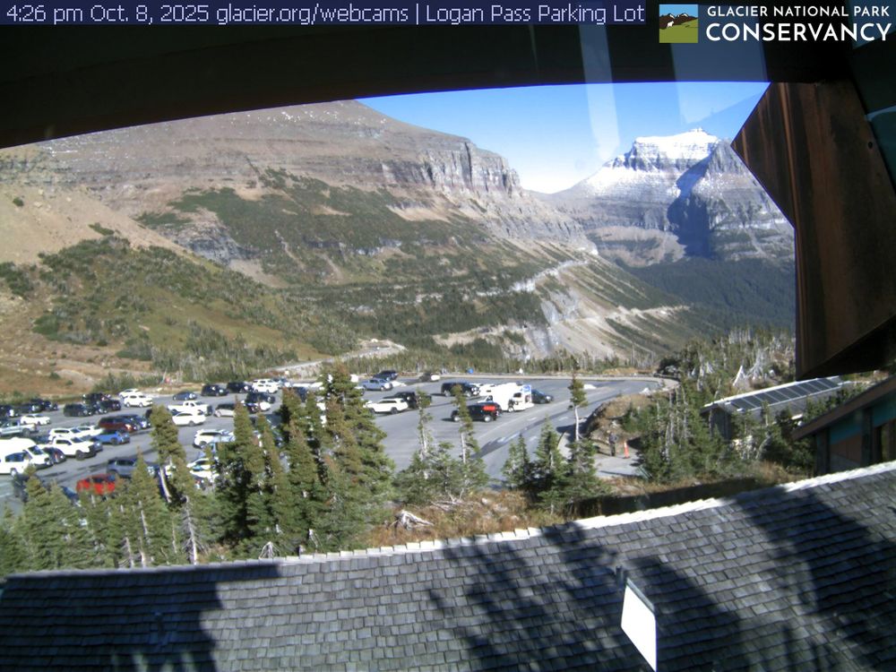 Located at the highest point along the Going-to-the-Sun Road, the Logan Pass area includes the Logan Pass Visitor Center, trailheads for the Highline and Hidden Lake trails, restrooms, potable water, and shuttle service. This view focuses on the Logan Pass parking lot with Mt. Pollock and Going-to-the-Sun Mountain in the background.

This webcam is brought to you through a partnership with the Glacier National Park Conservancy. Want to see all three Logan Pass webcams at the same time? Head to the Conservancy's website at the link below.