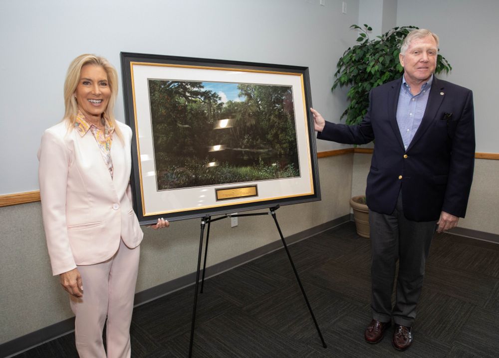 mayor deegan and harrison conyers standing next to a painting on an easel 