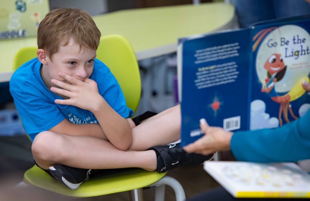A young student looking at a book 